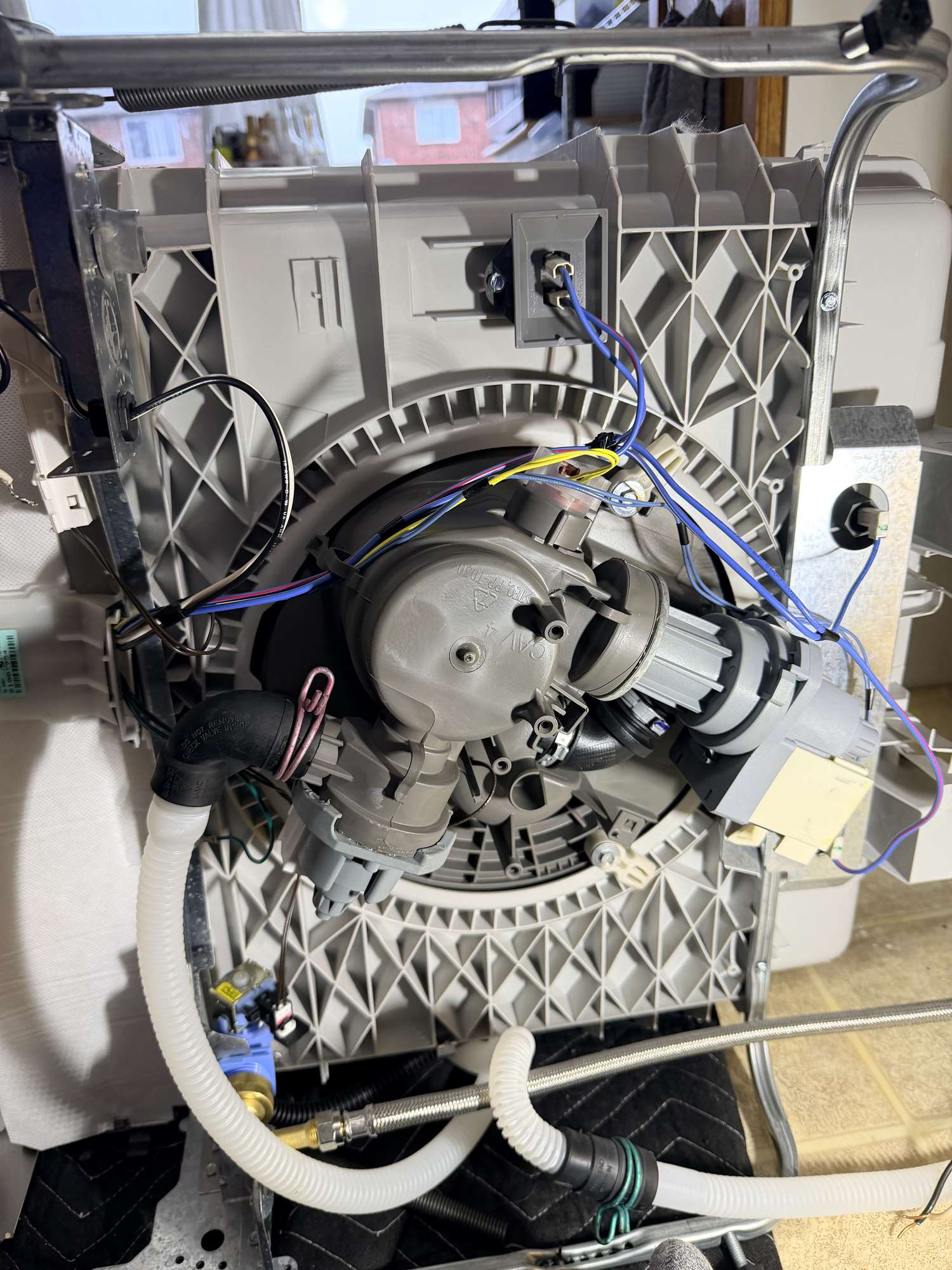 Accessing the kick plate of a Samsung dishwasher to check hose connections