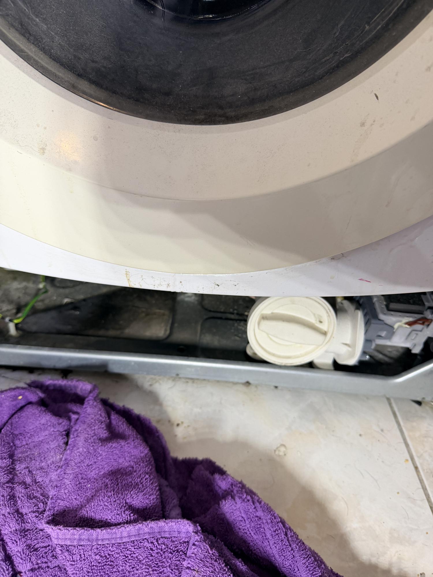 Close-up of a Samsung front-load washer drum with redistributing clothes to clear the DC error code