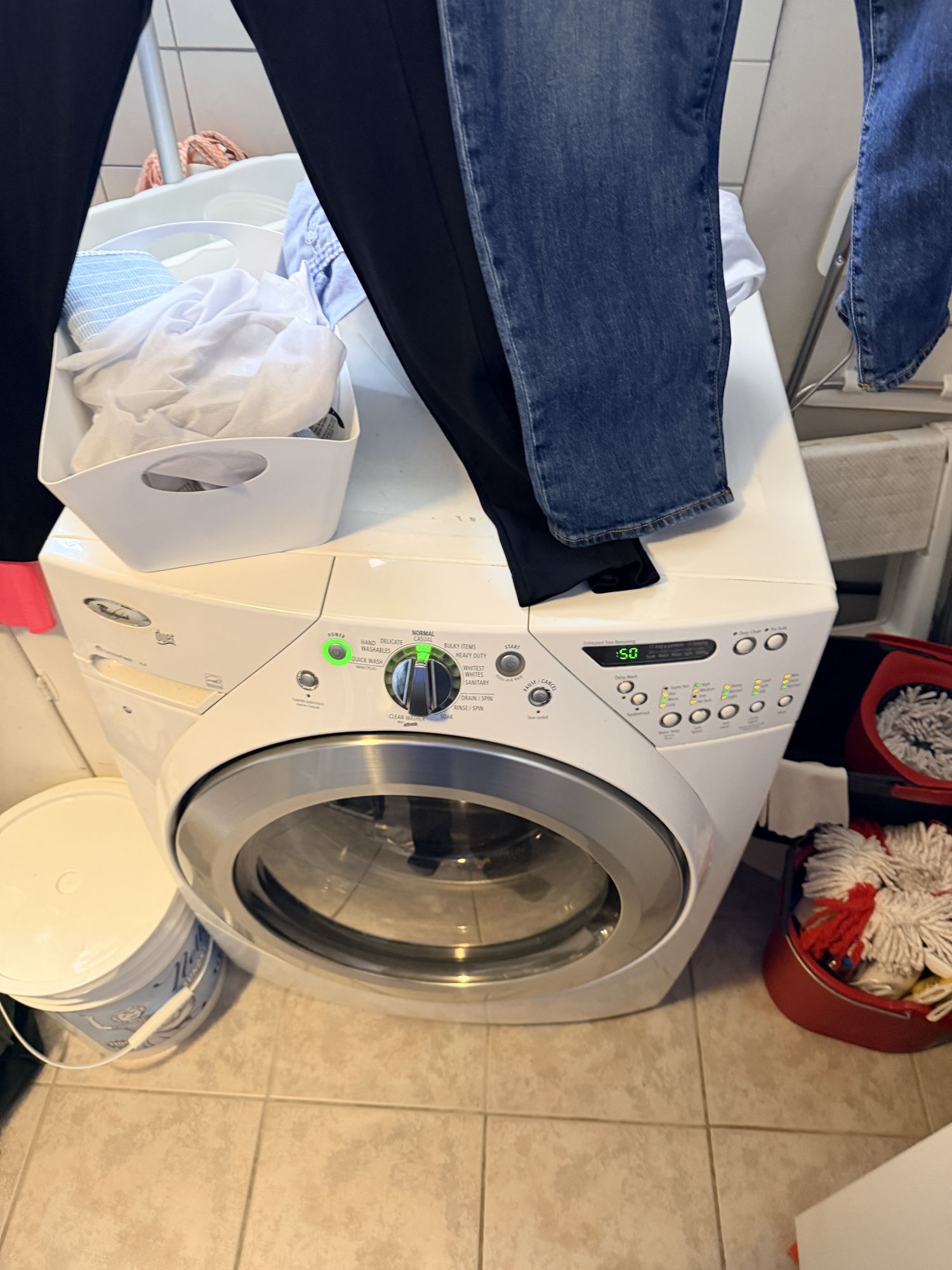 Open Whirlpool Duet front-load washer door showing the rubber gasket folds where mildew accumulates causing bad smell
