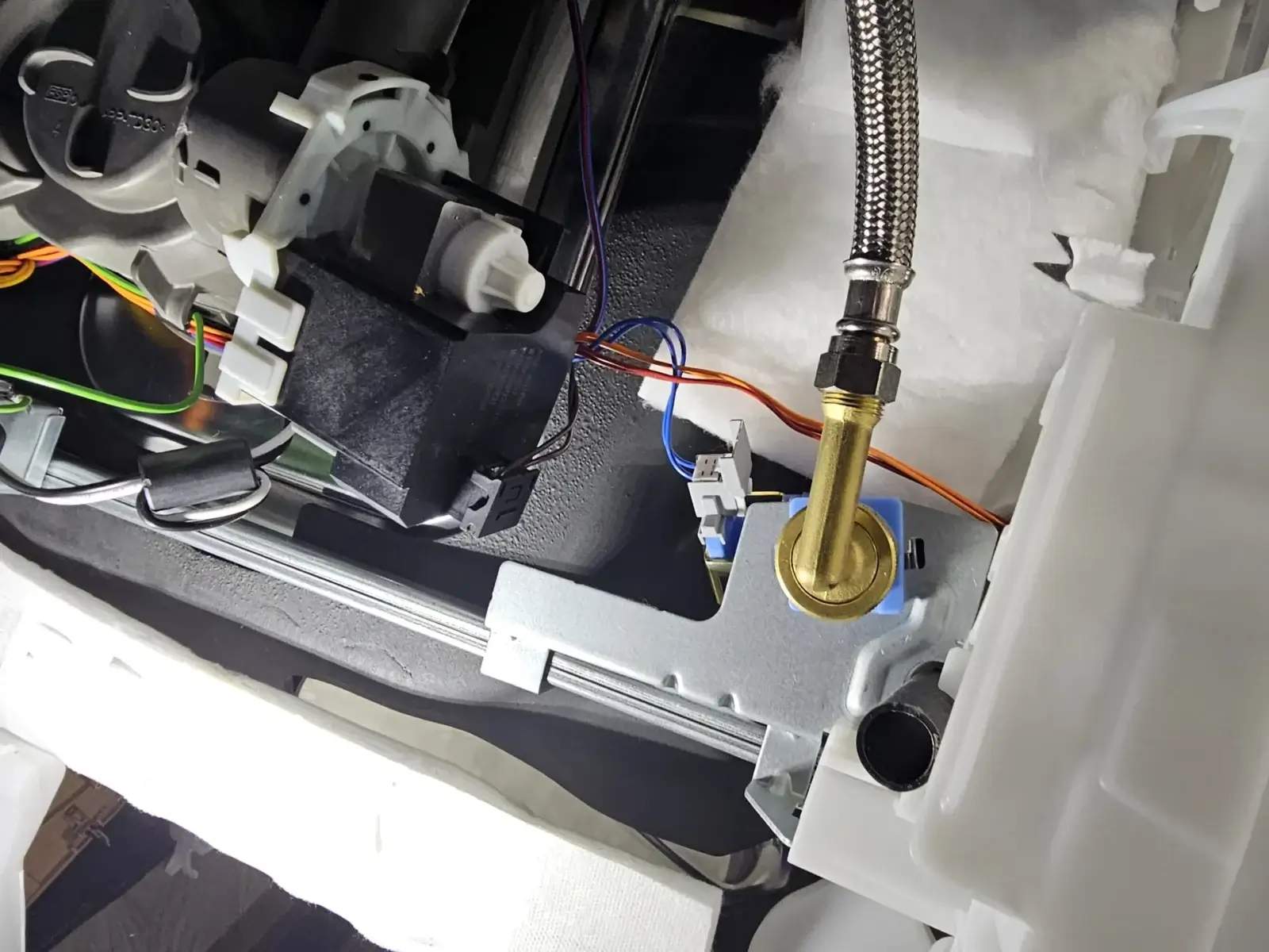 appliance repair close up plumbing wiring connections inside mechanical device i