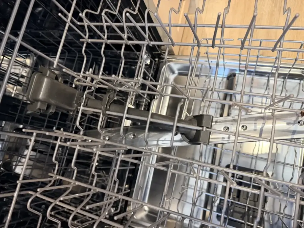 dishwasher repair open dishwasher metal racks spray arm visible appliance foreve